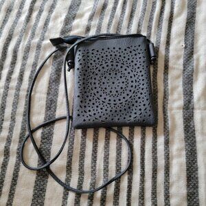 Unbranded crossbody with Lazer etched detail on front.